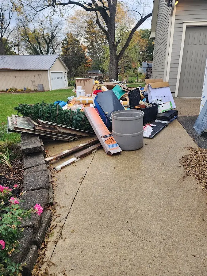Dumpster being loaded with debris for 12 Yard Dumpster Rental in Laredo